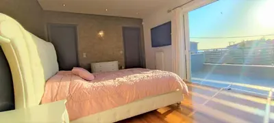 a bedroom with a bed and a view of a balcony at Unique Villa Melia Lagonisi in Kalívia Thorikoú