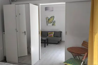 a living room with a couch and a mirror at Ilisos garden apartment in Athens