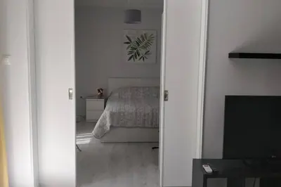 a view of a bedroom with a bed and a mirror at Ilisos garden apartment in Athens