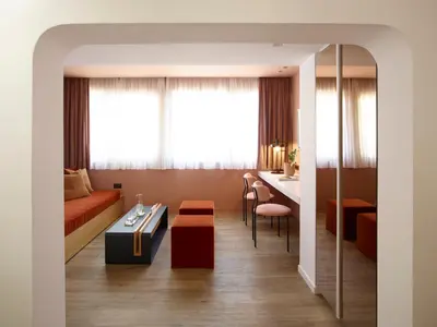 a living room with a couch and a table at The Marblous Athens in Athens