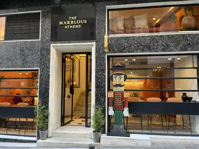 a store front with a statue in front of it at The Marblous Athens in Athens