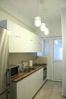 a kitchen with white cabinets and a sink at ARIS Piraeus Marina in Piraeus