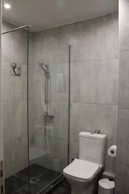 a bathroom with a toilet and a glass shower at ARIS Piraeus Marina in Piraeus