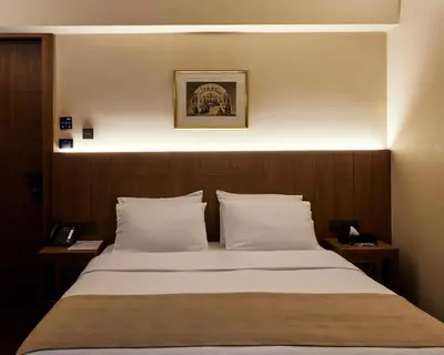 a bedroom with a large bed with white pillows at Athens 1890 Hotel & Spa in Athens
