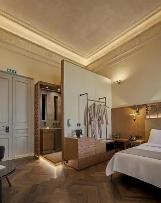 a large bedroom with a bed and a bathroom at Athens 1890 Hotel & Spa in Athens