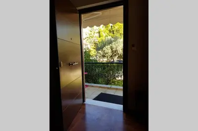 a hallway with a door leading to a balcony at Family House in Glyfada center in Athens
