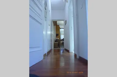 a hallway with white walls and a hard wood floor at Family House in Glyfada center in Athens
