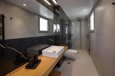 a bathroom with a sink and a toilet at Acropolis Golden Suites by GHH in Athens