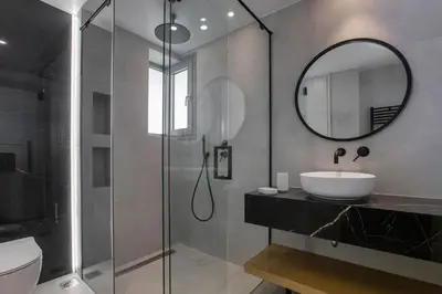 a bathroom with a sink and a mirror at Acropolis Golden Suites by GHH in Athens