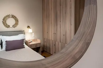 a bedroom with a bed with a round mirror at Absolute Athens XI in Athens