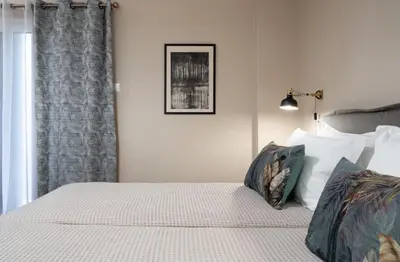 a bedroom with a bed with white sheets and pillows at Absolute Athens XI in Athens