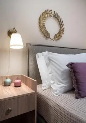 a bedroom with a bed with a lamp and a table at Absolute Athens XI in Athens