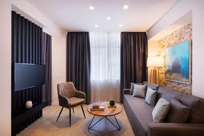 a living room with a couch and a table at Hestia - Romvis 9 in Athens