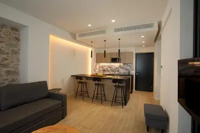 a living room and kitchen with a couch and a table at Hestia - Romvis 9 in Athens