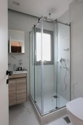 a bathroom with a glass shower and a sink at Hestia - Romvis 9 in Athens
