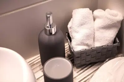 a bathroom with a bottle of soap and towels at Exclusive New Modern Apartment at Syntagma Square in Athens