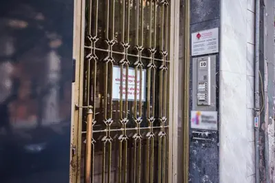 a gold gate on a door of a building at Exclusive New Modern Apartment at Syntagma Square in Athens