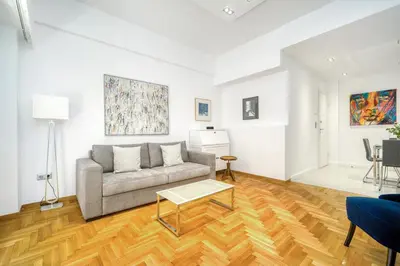 a living room with a couch and a table at Elegant Light Two Bedroom Apartment in City Center in Athens