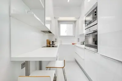 a white kitchen with white counters and white appliances at Elegant Light Two Bedroom Apartment in City Center in Athens