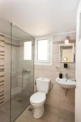 a bathroom with a toilet and a sink at So Athens - Stylish 2 bedroom flat in Athens