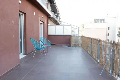 two chairs sitting on the balcony of a building at So Athens - Stylish 2 bedroom flat in Athens