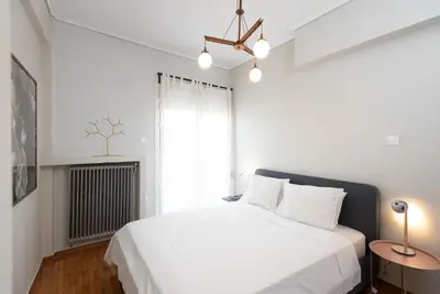 a bedroom with a white bed and a window at So Athens - Stylish 2 bedroom flat in Athens