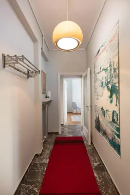a hallway with a red carpet and a ceiling at So Athens - Stylish 2 bedroom flat in Athens