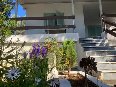 a garden in front of a house with flowers at Kokos Traditional Family House in Sounio