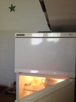 an open oven with a bowl inside of it at Kokos Traditional Family House in Sounio