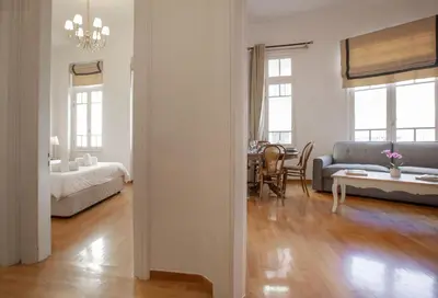 a living room with a couch and a table at Neoclassical Apartment close to Syntagma-Plaka by GHH in Athens