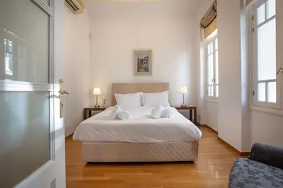 a bedroom with a bed with two towels on it at Neoclassical Apartment close to Syntagma-Plaka by GHH in Athens