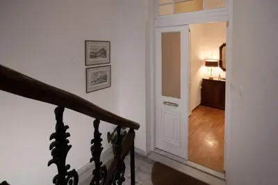a stairway leading to a hallway with a stair case at Neoclassical Apartment close to Syntagma-Plaka by GHH in Athens