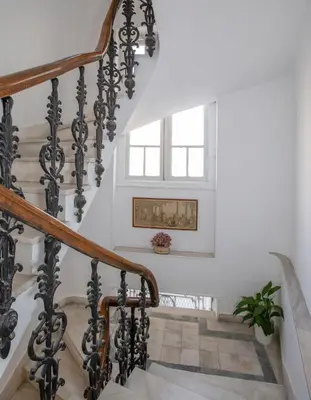 a staircase with black and white railings and a window at Neoclassical Apartment close to Syntagma-Plaka by GHH in Athens