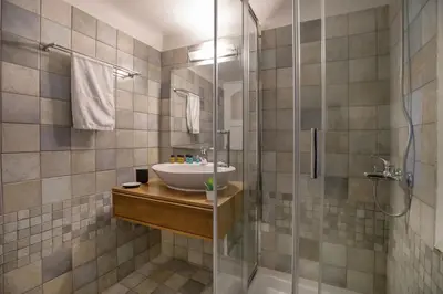 a bathroom with a sink and a shower at Neoclassical Apartment close to Syntagma-Plaka by GHH in Athens