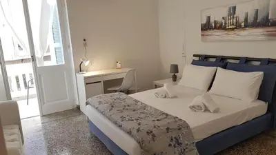 a bedroom with a bed and a desk in it at Ionian Apartment- Athens Center, 6 BD, 2.5 BATH in Athens