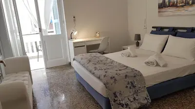 a bedroom with a bed and a desk in it at Ionian Apartment- Athens Center, 6 BD, 2.5 BATH in Athens