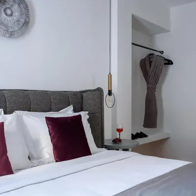 a bedroom with a bed with white and red pillows at Acropolis Grand Apartment in Athens