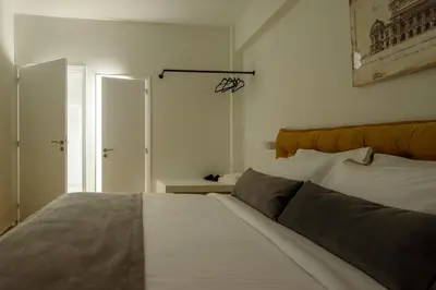 a bedroom with a large bed with an orange headboard at Acropolis Grand Apartment in Athens