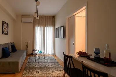a living room with a couch and a table at Acropolis Grand Apartment in Athens