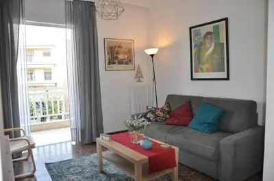 a living room with a couch and a table at Sunny Apartment with view in Athens