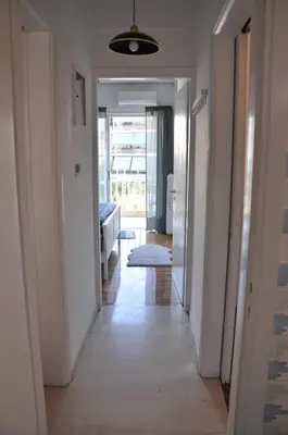 a hallway with a hallway leading to a living room at Sunny Apartment with view in Athens