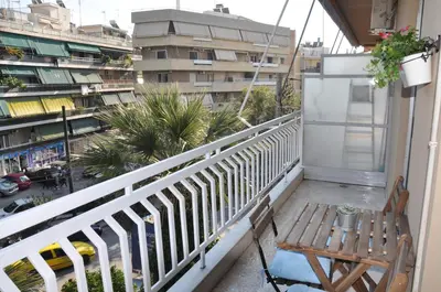 a balcony with a table and chairs and a view of a city at Sunny Apartment with view in Athens