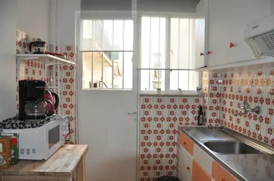 a kitchen with a sink and a microwave at Sunny Apartment with view in Athens