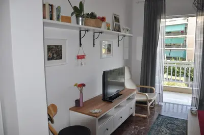 a living room with a tv on a dresser at Sunny Apartment with view in Athens