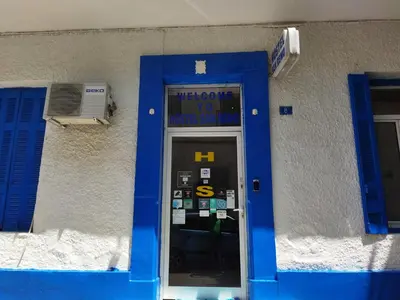 a door to a building with a blue door at SAN REMO HOSTEL in Athens