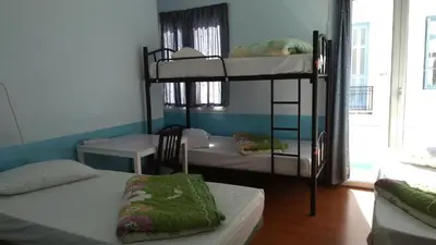 a room with three bunk beds in a room at SAN REMO HOSTEL in Athens