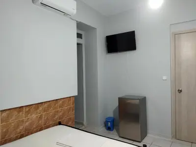 a room with a flat screen tv on the wall at SAN REMO HOSTEL in Athens