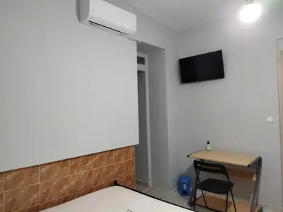 a room with a desk and a tv on the wall at SAN REMO HOSTEL in Athens