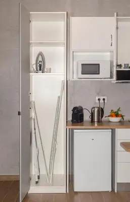 a kitchen with a white refrigerator and a microwave at Stylish Loft In Athens VIPGreece in Athens