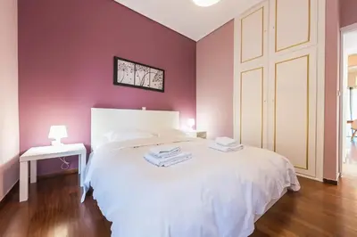 a bedroom with purple walls and a white bed at Glyfada Glass-Walled Designed Apt 1Gbps in Athens